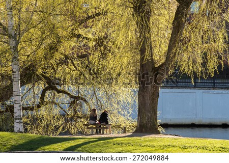 NORRKOPING, SWEDEN - APRIL 19: Two young women enjoy early spring on April 21, 2015 in Norrkoping. Spring in the southern part of Sweden is short, colorful and intense.