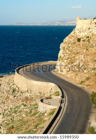 Bending road around the typical mediterranean fortress. Rethymno city. Crete island. Greece.