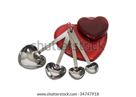 Red glass hearts and measuring spoons in the shape of hearts for cooking up love - path included