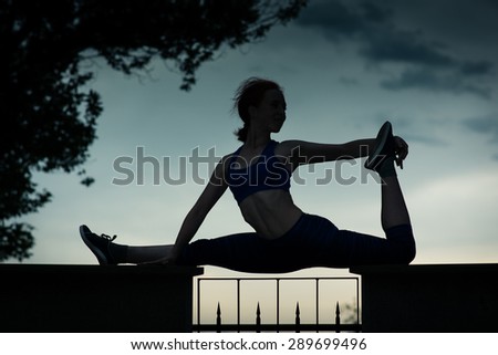 Silhouette against the sky, athletic girl doing gymnastics. Slim healthy body