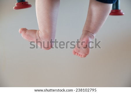 Childs feet hanging from a canvas chair