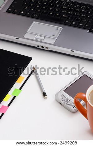 pocket pc, pen, laptop, book and coffee