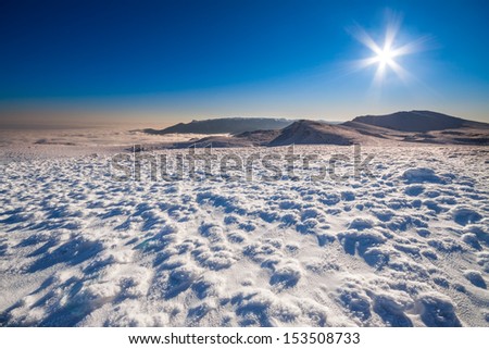 Sun and snow mountains landscape