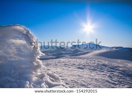 Sun and snow mountains landscape