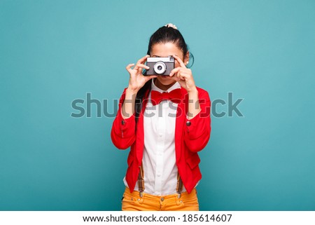Beautiful smiling woman (girl) holding a instant camera