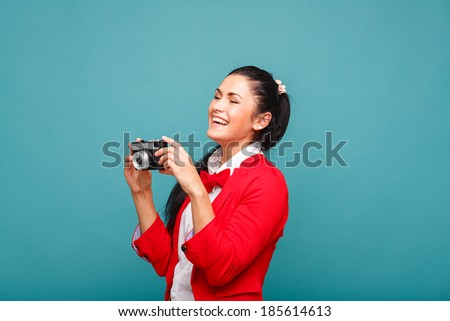 Beautiful smiling woman (girl) holding a instant camera
