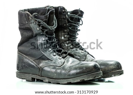 Black old combat military boots isolated on white background