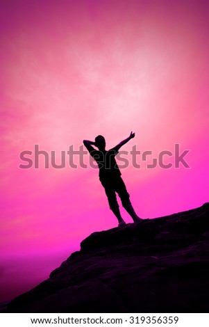 Silhouette of man on the rock of mountain with coloer light background for element design.