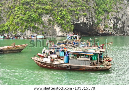 HALONG BAY, VIETNAM  JUNE 12: Fishing boats on June 12, 2010 in Halong Bay, Quang Ninh province, Vietnam. Halong Bay with its 2000 small islands became one of the new 7 Wonders of Nature in 2012.
