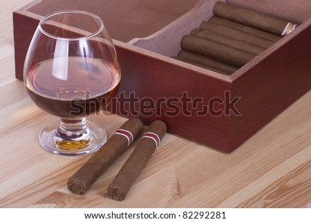 Glass of brandy and cigars