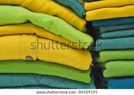 Stack of women's sweaters and cardigans in bright vivid colours