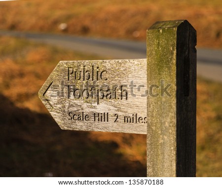 Public Footpath Sign.  A wooden signpost marking a public footpath close to Crummock Water in the English Lake District national park.