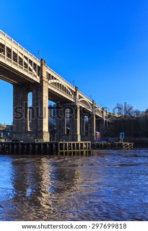 High Level Bridge.  The High Level Bridge is a road and railway bridge spanning the River Tyne between Newcastle upon Tyne and Gateshead in North East England.