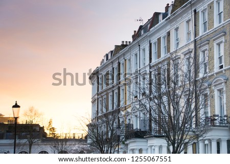 A row of typical townhouses in Kensington & Chelsea area of London with a sunset background Сток-фото © 