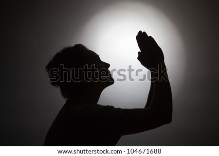 Silhouette of praying woman