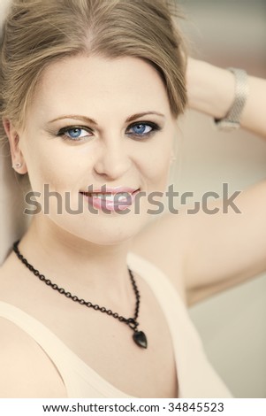Portrait of beautiful smiling woman with blue eyes.