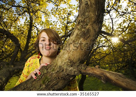 Funny young beautiful woman make faces  in autumn park