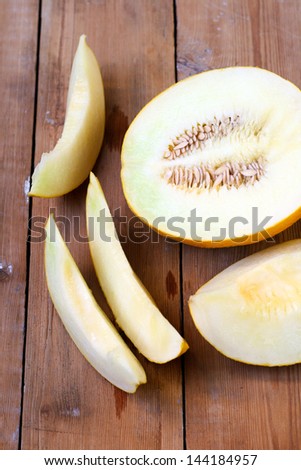 Melon cut on slices on the wooden table