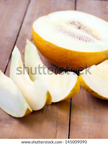 Melon cut on slices on the wooden table