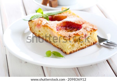 Slice of plum cake and cup of coffee