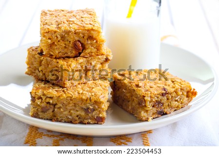 Pumpkin and oat bars with raisin and bottle of milk, selective focus