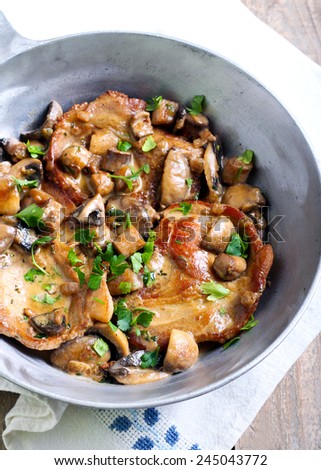Pork chops in mushroom marsala sauce in pan