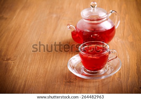 Red herbal and fruit tea in cup and tea pot