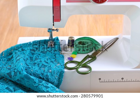 Sewing machine and sewing accessories on wooden table