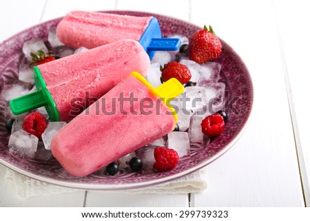 Mixed berry and yogurt ice cream pops on plate