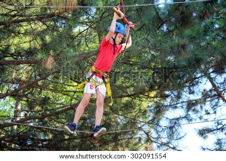 Boy in rope attraction park
