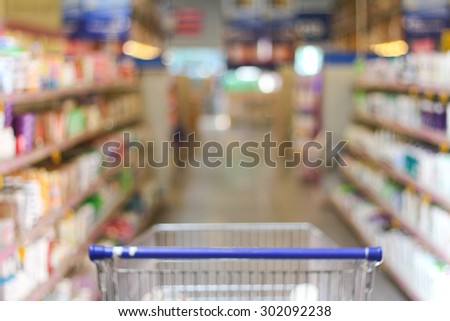 Blurred background of Supermarket with shopping cart