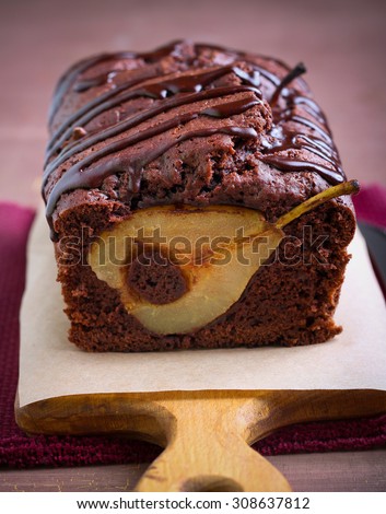 Chocolate pear loaf cake with chocolate drizzle on board
