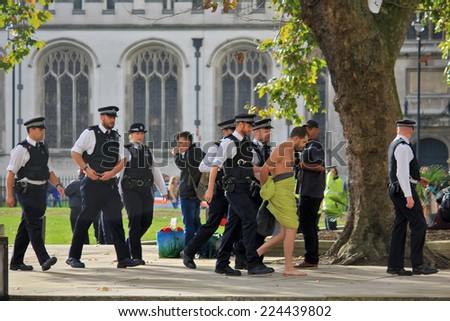 LONDON - OCTOBER 18, 2014: Thousands of people have protested in London about pay and austerity. Many have been arrested by police. Parliament street, London, UK, October 18, 2014.
