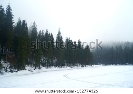 The surface of a high mountain lake in winter Carpathians