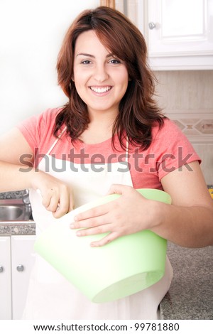 Happy woman making cake in the kitchen