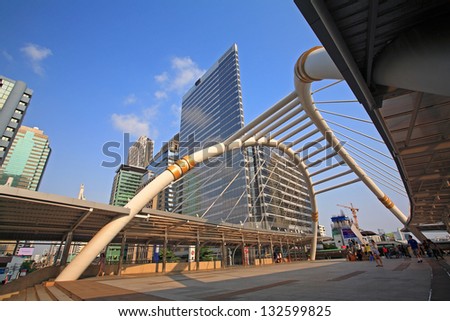 BANGKOK-MAR 16: Public sky walk for passengers to transit between Sky Transit and Bus Rapid Transit Systems against blue sky at Sathorn-Narathiwas junction on March 16, 2013 in Bangkok, Thailand.