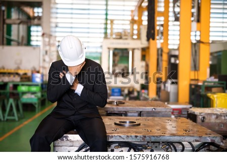 Broke Factory manager or businessman owner cry on machine. Business and factory industry close due to COVID-19 or coronavirus disease impact. Leave without pay, work from home, quarantine, bankruptcy. Stock photo © 