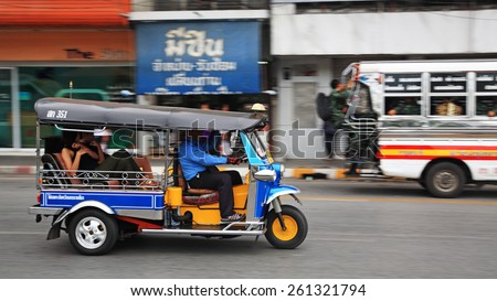 KORAT, THAILAND - JULY 18, 2014: tuk tuk taxi with passengers transport in the city. Tuk tuks can be hired from as little as $1 or B30 a fare for shop trips.