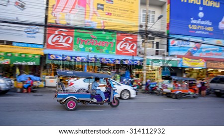 KORAT, THAILAND - SEPTEMBER 05, 2015: Motion motor tricycle called Tuk Tuk riding in city. Tuk Tuk is used for transit around Korat or Nakhon Ratchasima downtown.