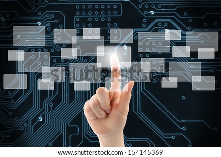 Woman hand using touch screen interface on circuit board background