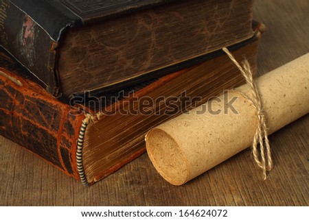 Retro composition with books and paper on wooden background