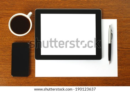 Tablet PC, smart phone, paper, pen and cup of coffee on wooden background