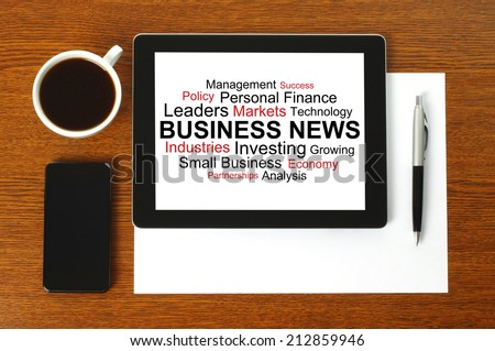 Tablet PC with business news, smart phone, paper, pen and cup of coffee on wooden background