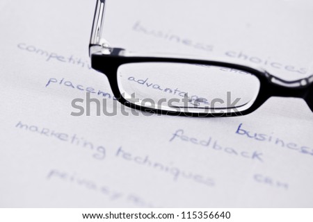 business words with glasses focusing on  competitive advantage