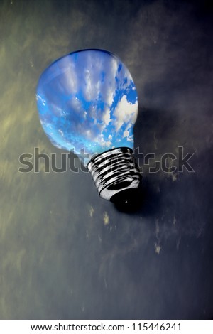 lightbulb with clean sky inside surrounded by dark pollution