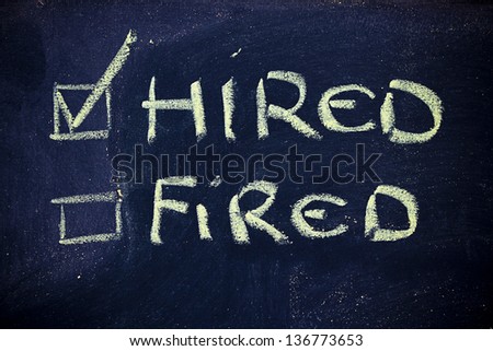 chalk writings on blackboard, hired vs. fired