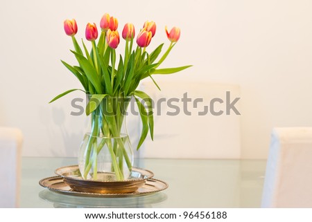 home interior decoration, vase of tulips on glass table