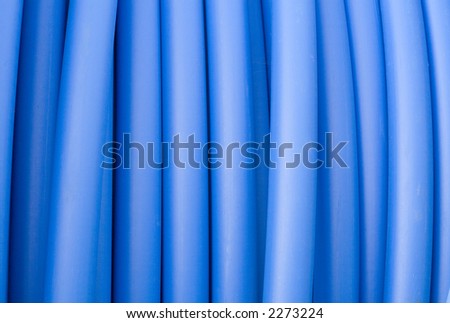 Closeup of blue electricity cable of pipeline.