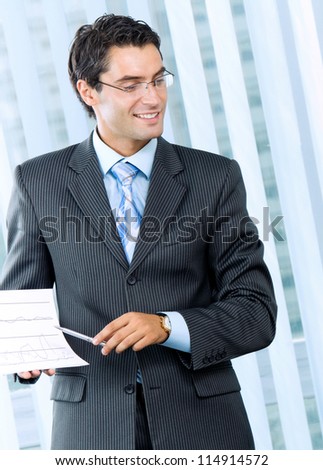 Cheerful businessman at business meeting, seminar, conference or training
