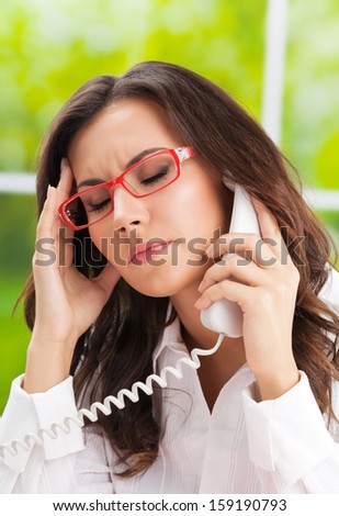 Thinking, tired or ill with headache business woman with phone at office